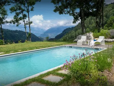 a swimming pool with a view of mountains at Chalet Beau Caillou - OVO Network in Saint-Gervais-les-Bains