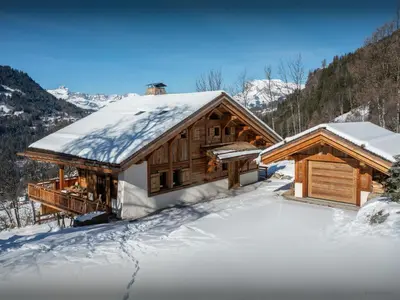 a log cabin with snow on the ground at Chalet Beau Caillou - OVO Network in Saint-Gervais-les-Bains