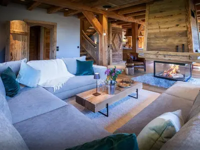 a living room with couches and a fireplace at Chalet Beau Caillou - OVO Network in Saint-Gervais-les-Bains