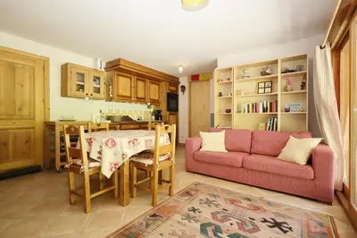 a living room with a red couch and a table at Résidence Le Hameau Des Glaciers - Hameau des Glaciers D02 MAE-5834 in Les Houches