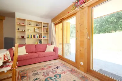a living room with a red couch and a window at Résidence Le Hameau Des Glaciers - Hameau des Glaciers D02 MAE-5834 in Les Houches