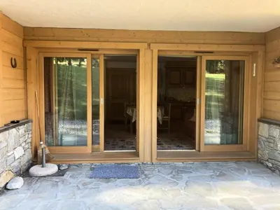 an entry to a house with sliding glass doors at Résidence Le Hameau Des Glaciers - Hameau des Glaciers D02 MAE-5834 in Les Houches