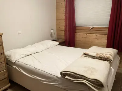 a bedroom with a bed with white sheets and a window at Résidence Le Hameau Des Glaciers - Hameau des Glaciers D02 MAE-5834 in Les Houches