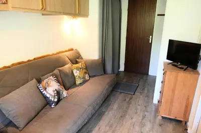 a living room with a couch and a television at Résidence Cristal - Cristal 161 MAE-5824 in Mémontel