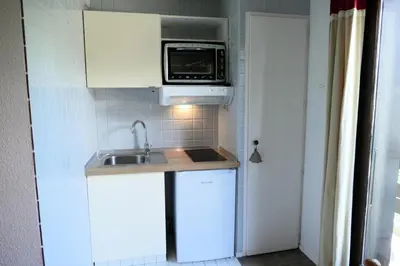 a small kitchen with a sink and a microwave at Résidence Cristal - Cristal 161 MAE-5824 in Mémontel