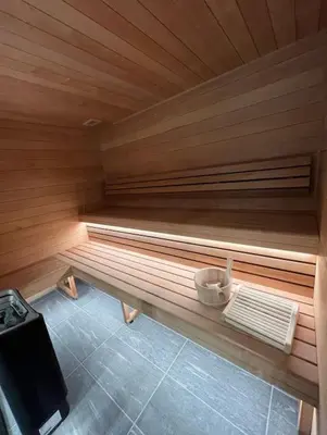 a sauna with a bench in the middle of a room at Les Chamois D’Arbois, Mont D’Arbois, Megève in Megève