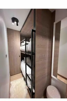 a room with three bunk beds in a room at Les Chamois D’Arbois, Mont D’Arbois, Megève in Megève
