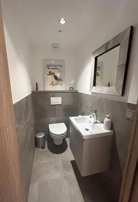 a bathroom with a sink and a toilet and a mirror at Les Chamois D’Arbois, Mont D’Arbois, Megève in Megève