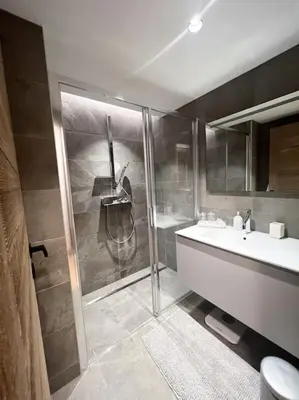 a bathroom with a shower and a toilet and a sink at Les Chamois D’Arbois, Mont D’Arbois, Megève in Megève