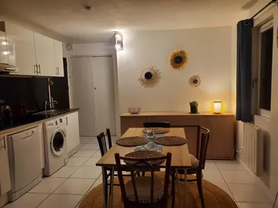 a kitchen with a table and chairs in a kitchen at Studio avec petit balcon et cheminée - Grand Massif in Les Carroz d'Araches