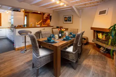 a dining room with a wooden table and chairs at Chalet des Favrands in Chamonix-Mont-Blanc