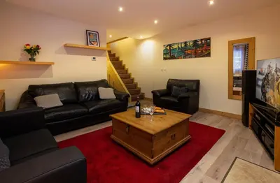 a living room with a couch and a coffee table at Chalet des Favrands in Chamonix-Mont-Blanc