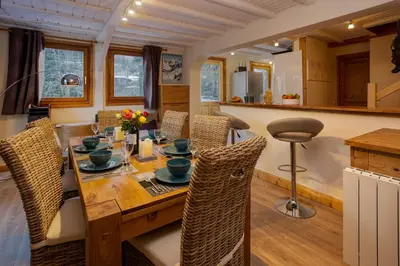 a dining room with a wooden table and chairs at Chalet des Favrands in Chamonix-Mont-Blanc