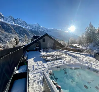 a hot tub covered in snow in front of a house at Appartement Rooftop Chamonix in Chamonix-Mont-Blanc