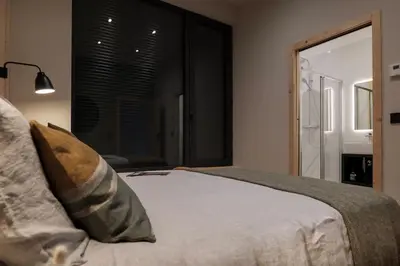 a bedroom with a bed and a large window at Appartement Rooftop Chamonix in Chamonix-Mont-Blanc