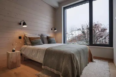 a bedroom with a bed and a large window at Appartement Rooftop Chamonix in Chamonix-Mont-Blanc