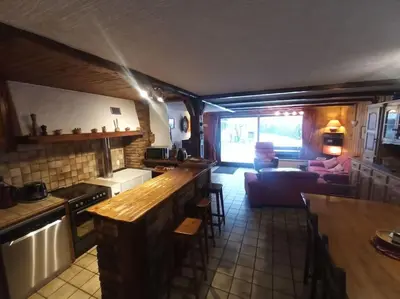 a kitchen and a living room with a couch at Belle Vue Des Praz in Chamonix-Mont-Blanc