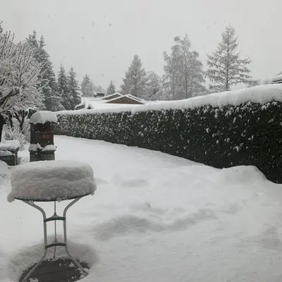 a yard covered in snow with a snow covered bench at Belle Vue Des Praz in Chamonix-Mont-Blanc