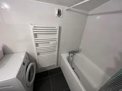 a white bathroom with a washing machine and a tub at Chaleureux 3 pièces + mezzanine, 6/7 pers, poêle à bois, balcon ouest, parking, proche centre et pistes - FR-1-572-271 in Arâches-la-Frasse