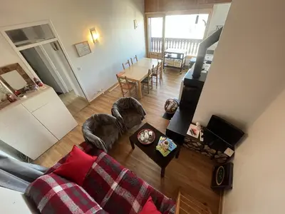 a living room with a couch and a table at Chaleureux 3 pièces + mezzanine, 6/7 pers, poêle à bois, balcon ouest, parking, proche centre et pistes - FR-1-572-271 in Arâches-la-Frasse