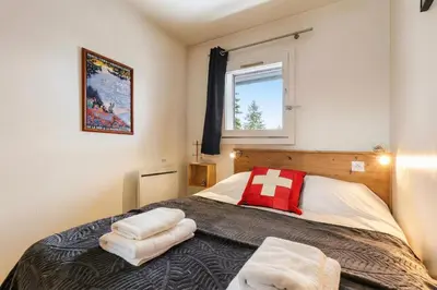 a kitchen with a wooden table with a vase of flowers at Chamonix Sud - Bâtiment Iris 357 - Happy Rentals in Chamonix-Mont-Blanc