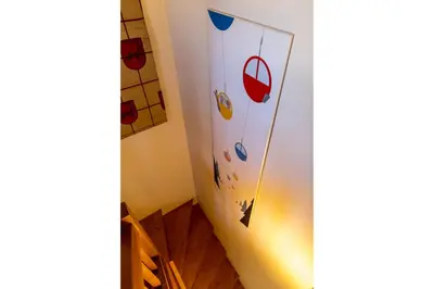 a room with a staircase with a wall with stickers on it at Chalet le Tremplin in Chamonix-Mont-Blanc