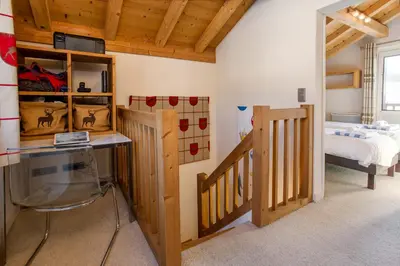 a bedroom with a bed and a desk in a room at Chalet le Tremplin in Chamonix-Mont-Blanc