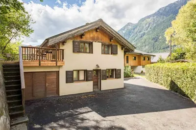 a house with a garage and a driveway at Chalet le Tremplin in Chamonix-Mont-Blanc