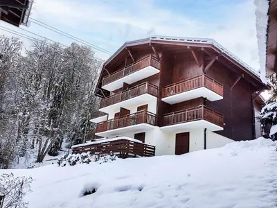 a building on the side of a grassy hill at Studio La Piste B71 by Interhome in Saint-Gervais-les-Bains