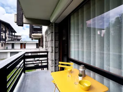 a yellow table and chairs on a balcony at Apartment Le Nerey-2 by Interhome in Saint-Gervais-les-Bains