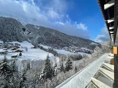 a view from the balcony of a resort in the snow at Cozy studio au centre du village & superbe vue in Les Contamines-Montjoie