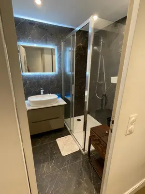 a bathroom with a glass shower and a sink at Cozy studio au centre du village & superbe vue in Les Contamines-Montjoie