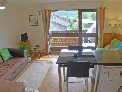 a living room with a couch and a table at Studio lumineux pour 4 pers, animaux admis, wifi inclus, au centre de Samoëns - FR-1-629-120 in Samoëns