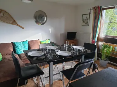a bunk bed with a blue and white comforter at Studio lumineux pour 4 pers, animaux admis, wifi inclus, au centre de Samoëns - FR-1-629-120 in Samoëns