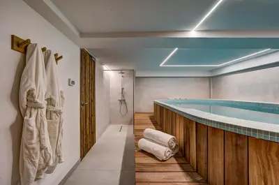 a bathroom with a swimming pool and a tub at Chalet Green Forest in Chamonix-Mont-Blanc