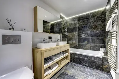 a bathroom with a sink and a tub and a toilet at Chalet Green Forest in Chamonix-Mont-Blanc