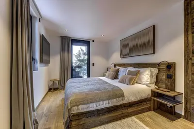 a bedroom with a large bed and a window at Chalet Green Forest in Chamonix-Mont-Blanc