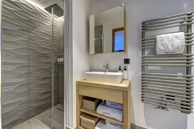 a bathroom with a sink and a shower at Chalet Green Forest in Chamonix-Mont-Blanc
