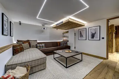 a living room with a couch and a table at Chalet Green Forest in Chamonix-Mont-Blanc