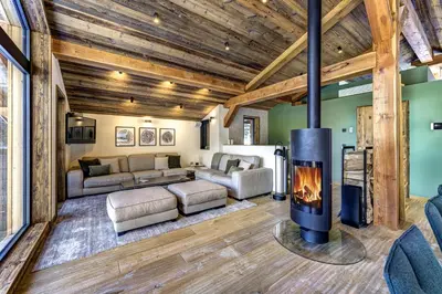 a living room with a fireplace in a house at Chalet Green Forest in Chamonix-Mont-Blanc