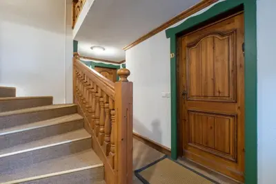 a hallway with stairs and a wooden door at Apartment Husky in Saint-Gervais-les-Bains