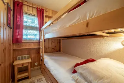 two bunk beds in a room with a window at Apartment Husky in Saint-Gervais-les-Bains