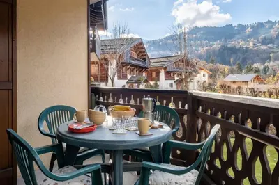 a table and chairs on a balcony with a view at Apartment Husky in Saint-Gervais-les-Bains