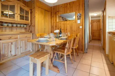 a kitchen with a wooden table and chairs at Apartment Husky in Saint-Gervais-les-Bains