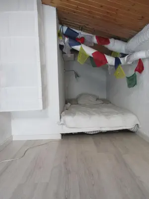 a room with a bed and a chair and a window at Beau duplex lumineux à la montagne Nice flat just underneath MtBlanc in Les Houches