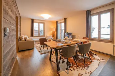 a dining room with a table and chairs at Perle Blanche - Brand New 2 bedroom apartment perfectly located in Chamonix-Mont-Blanc