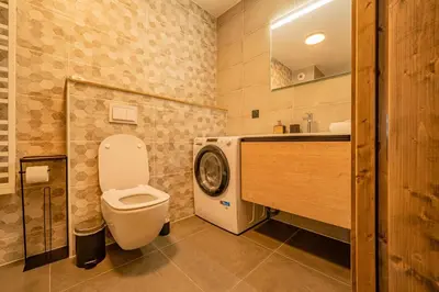 a bathroom with a toilet and a sink at Perle Blanche - Brand New 2 bedroom apartment perfectly located in Chamonix-Mont-Blanc
