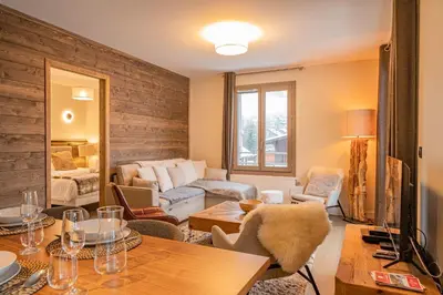 a living room with a couch and a table at Perle Blanche - Brand New 2 bedroom apartment perfectly located in Chamonix-Mont-Blanc