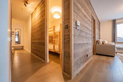a large wooden wall in a room with a bunk bed at Perle Blanche - Brand New 2 bedroom apartment perfectly located in Chamonix-Mont-Blanc