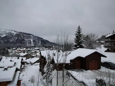 a small village covered in snow with a mountain at Studio spacieux 4 pers : parking, lave-vaisselle, proche télécabine - FR-1-572-108 in Arâches-la-Frasse